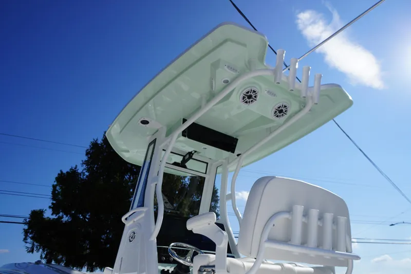 Slide: The Image of 2026 Tidewater 272 LXF boat with T-top and rod holders under clear blue sky. - 66