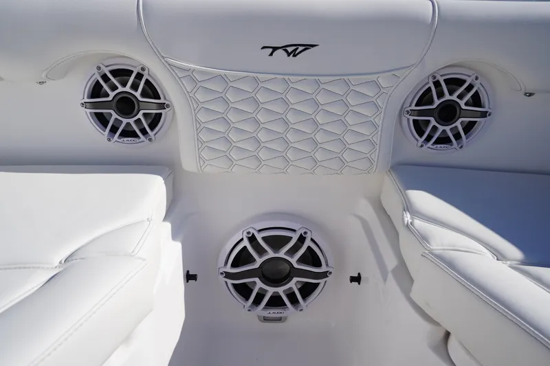 Slide: The Image of 2026 Tidewater 272 LXF boat interior with JL Audio speakers and stylish white seating. - 8