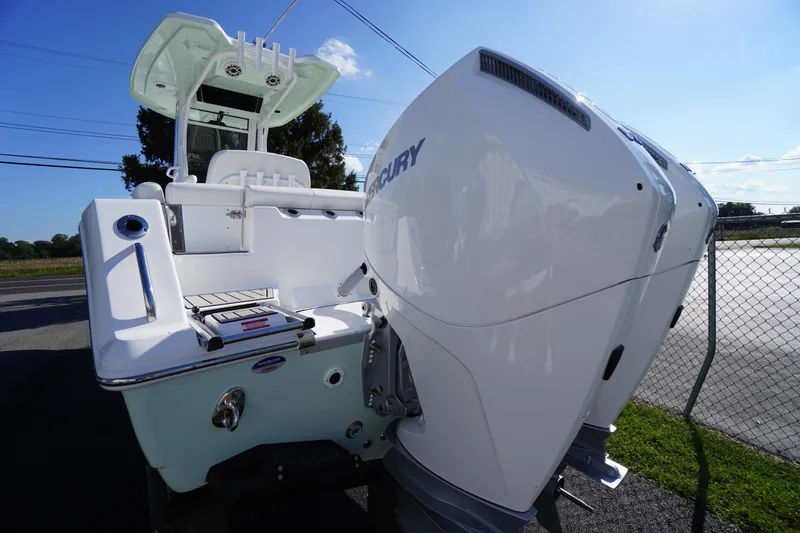 Slide: The Image of 2026 Tidewater 272 LXF boat with dual Mercury engines, docked outdoors. - 80