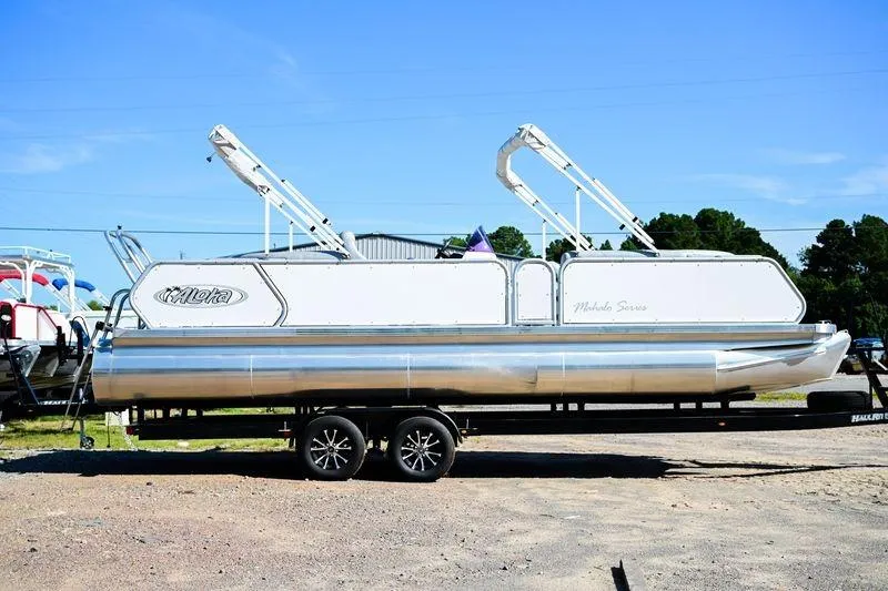 The Image of 2023 Aloha Pontoon Mahalo 23 on trailer, parked outdoors under clear blue sky. - 0