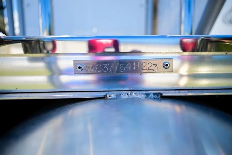 Slide: The Image of 2023 Aloha Pontoon Mahalo 23, close-up of hull identification number plate. - 11