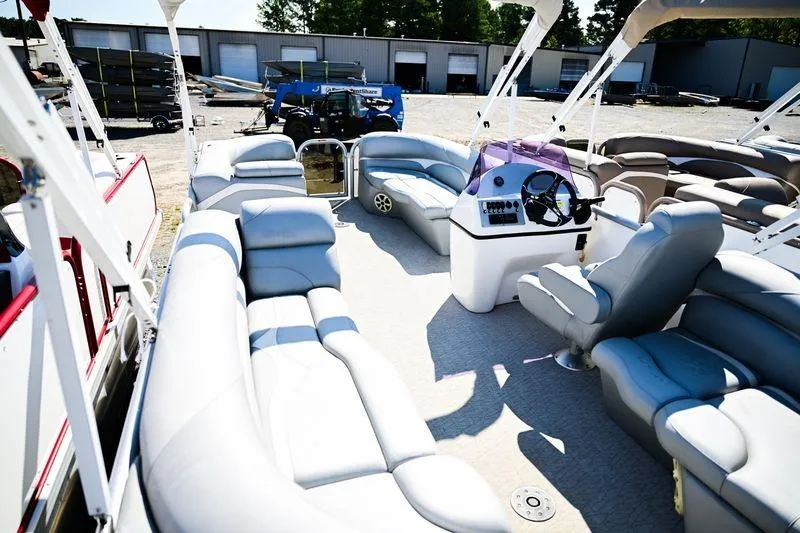 Slide: The Image of 2023 Aloha Pontoon Mahalo 23 boat interior with plush seating and steering console. - 8