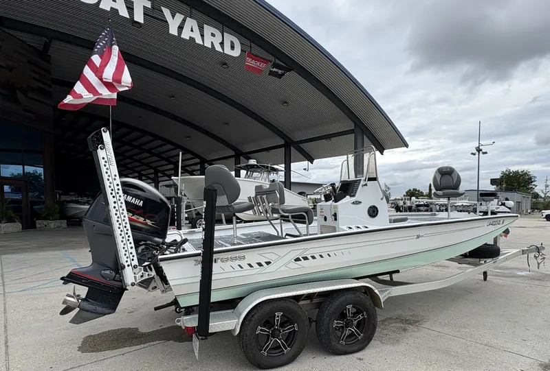Slide: The Image of 2020 Xpress H20 B boat with Yamaha engine at a boat yard, featuring an American flag. - 3