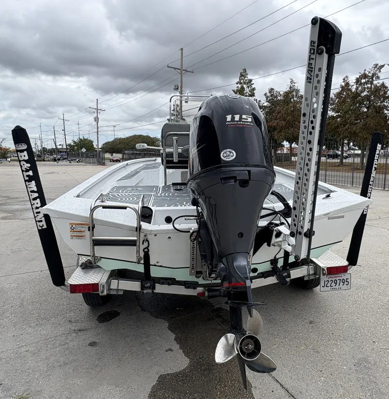 Slide: The Image of 2020 Xpress H20 B boat with 115 horsepower outboard motor, parked on a trailer. - 9