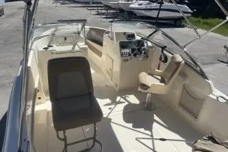 Slide: The Image of 2022 Scout 210 Dorado boat interior with seating and steering console. - 6