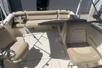 Slide: The Image of 2022 Scout 210 Dorado boat interior with beige seating and steering wheel. - 8