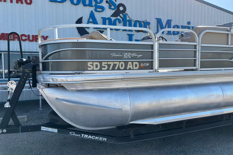 Slide: The Image of 2017 Sun Tracker Fishin' Barge 22 XP3 pontoon boat on trailer at marina. - 10