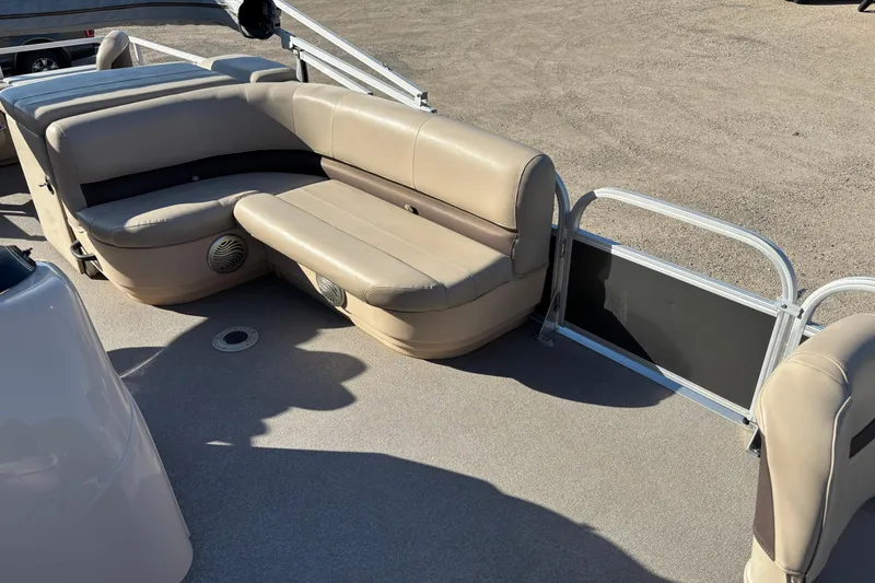 Slide: The Image of 2017 Sun Tracker Fishin' Barge 22 XP3 interior with beige seating and speaker system. - 14