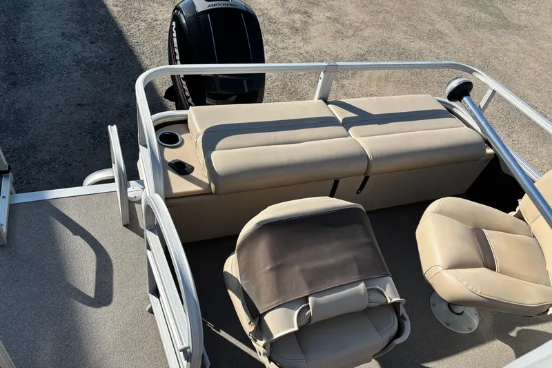 Slide: The Image of 2017 Sun Tracker Fishin' Barge 22 XP3 interior with beige seating and Mercury outboard motor. - 18