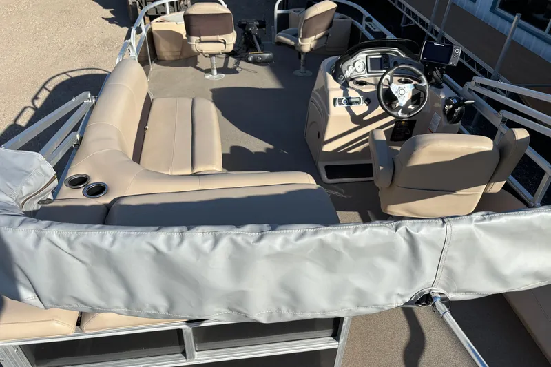 Slide: The Image of 2017 Sun Tracker Fishin' Barge 22 XP3 interior with beige seating and steering console. - 19