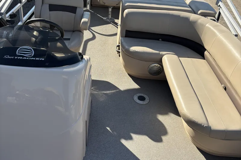 Slide: The Image of 2017 Sun Tracker Fishin' Barge 22 XP3 interior with beige seating and steering console. - 20