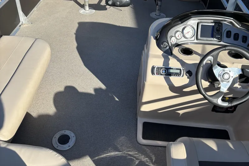 Slide: The Image of 2017 Sun Tracker Fishin' Barge 22 XP3 interior with steering wheel and seating. - 21