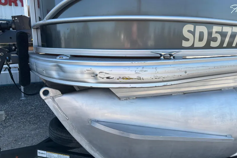 Slide: The Image of 2017 Sun Tracker Fishin' Barge 22 XP3 with visible hull scratches and registration number. - 23