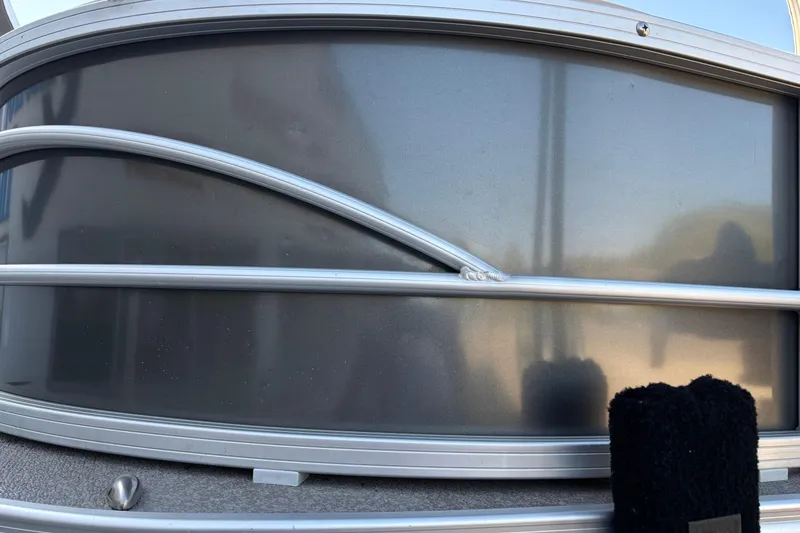 Slide: The Image of 2017 Sun Tracker Fishin' Barge 22 XP3 pontoon boat side view with sleek metal railing. - 3