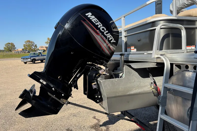 Slide: The Image of 2017 Sun Tracker Fishin' Barge 22 XP3 with Mercury outboard motor, parked on gravel. - 6