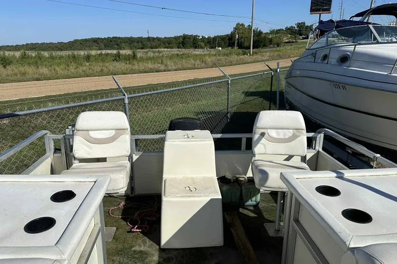 Slide: The Image of 2003 Beachcomber 24 Fish & Play boat interior with seating and storage compartments. - 10