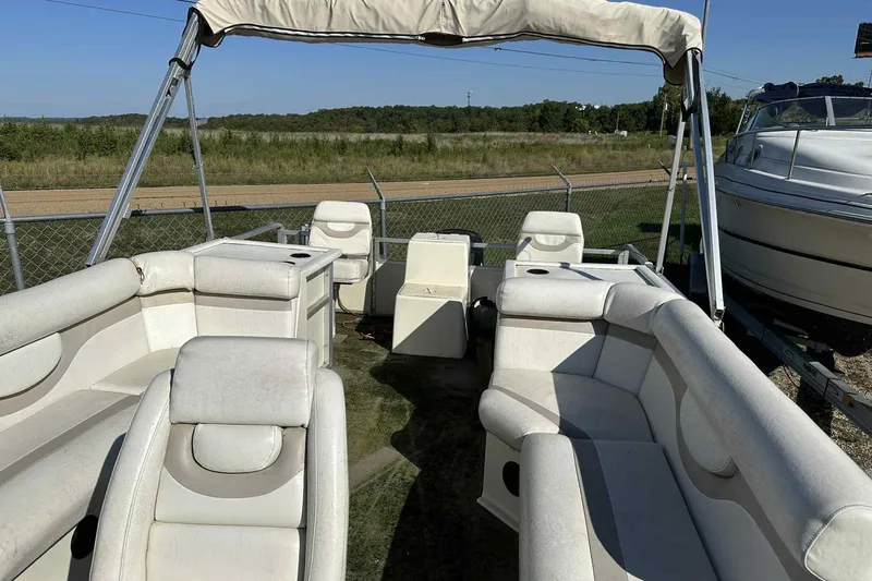 Slide: The Image of 2003 Beachcomber 24 Fish & Play pontoon boat with spacious seating and canopy. - 2