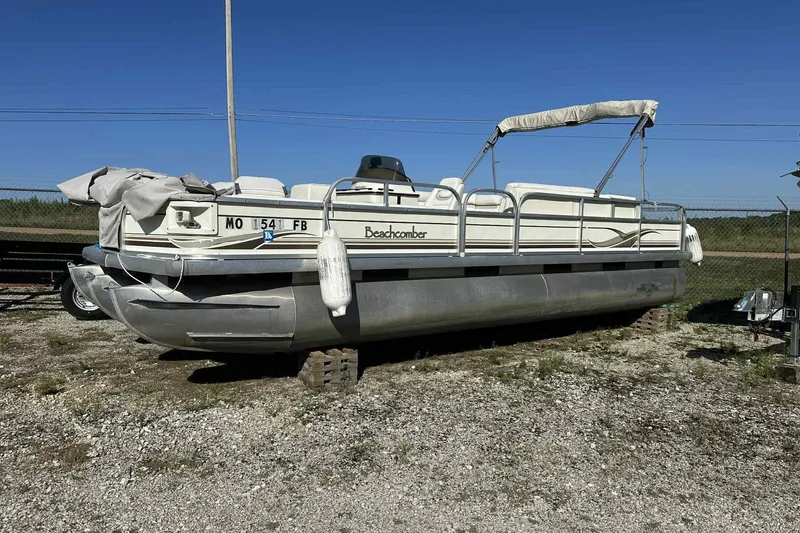 Slide: The Image of 2003 Beachcomber 24 Fish & Play pontoon boat on dry land, with canopy and fenders. - 8