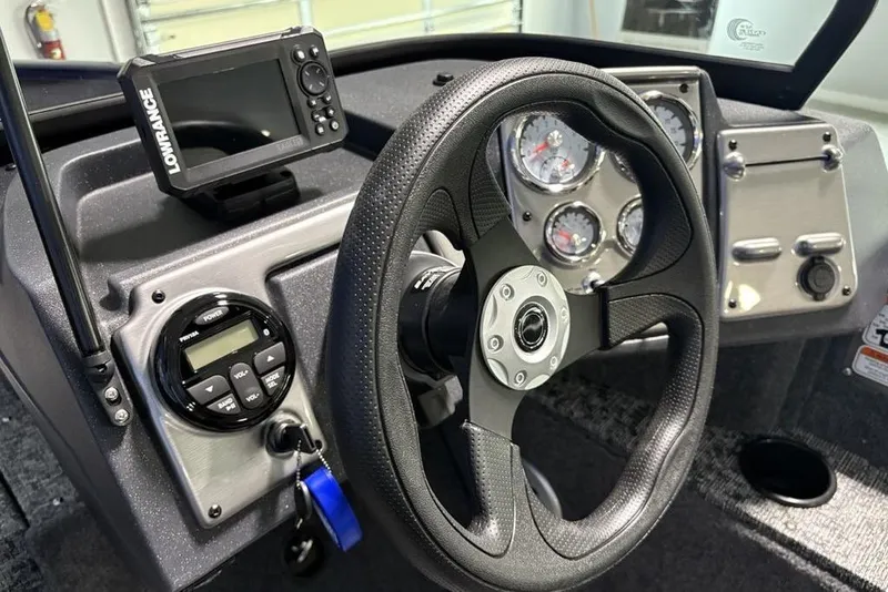 Slide: The Image of 2026 Tracker Pro Guide V-175 Combo dashboard with steering wheel and Lowrance display. - 18