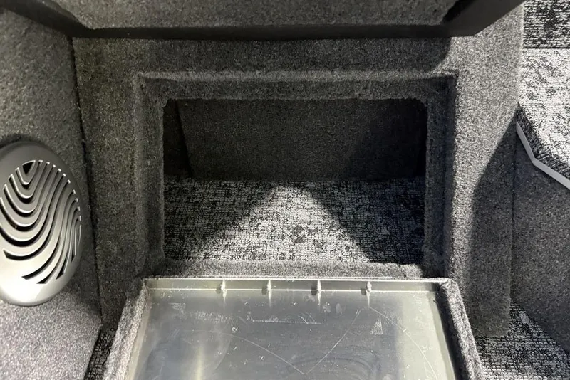 Slide: The Image of Interior view of 2026 Tracker Pro Guide V-175 Combo boat, featuring carpeted storage area. - 20