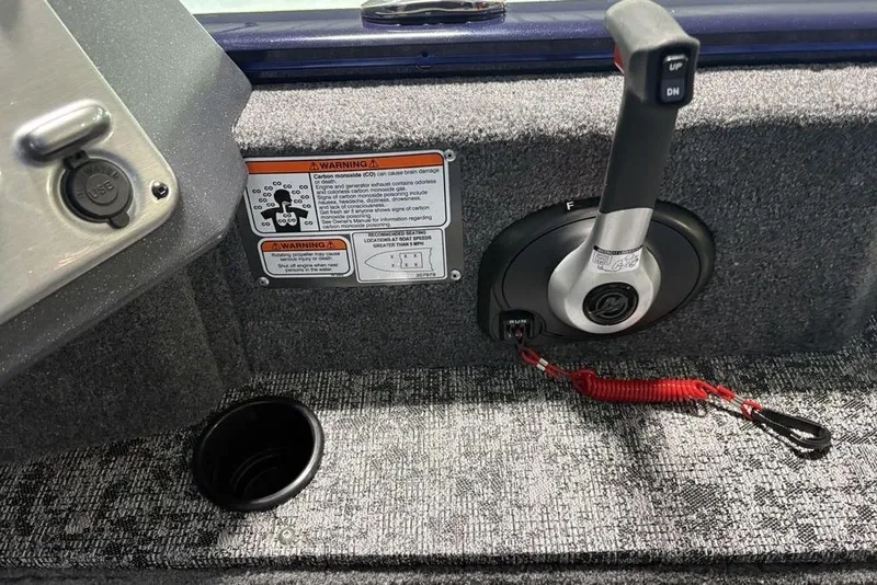 Slide: The Image of 2026 Tracker Pro Guide V-175 Combo boat control panel with warning labels and USB port. - 23