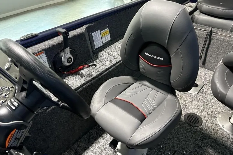 Slide: The Image of 2026 Tracker Pro Guide V-175 Combo boat interior with steering wheel and cushioned seat. - 24