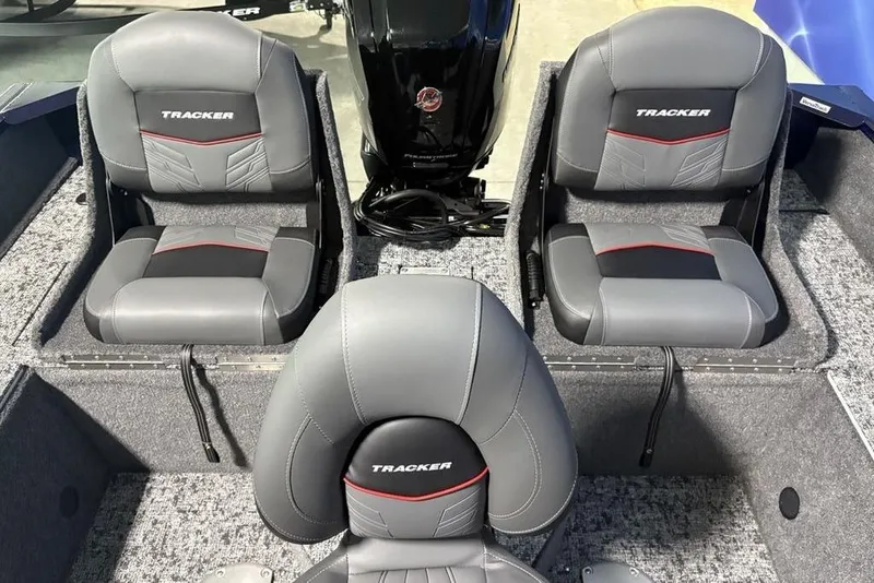 Slide: The Image of 2026 Tracker Pro Guide V-175 Combo boat seats, gray with red accents, interior view. - 33