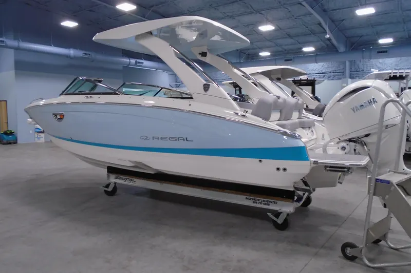 The Image of 2026 Regal LX6 boat in showroom with Yamaha engine, sleek design, and modern features. - 0