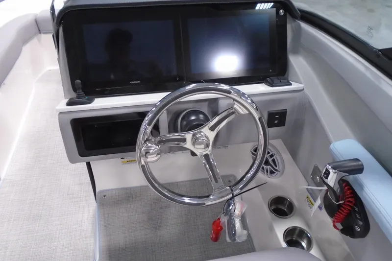 Slide: The Image of 2026 Regal LX6 boat dashboard with dual screens and modern steering wheel. - 13
