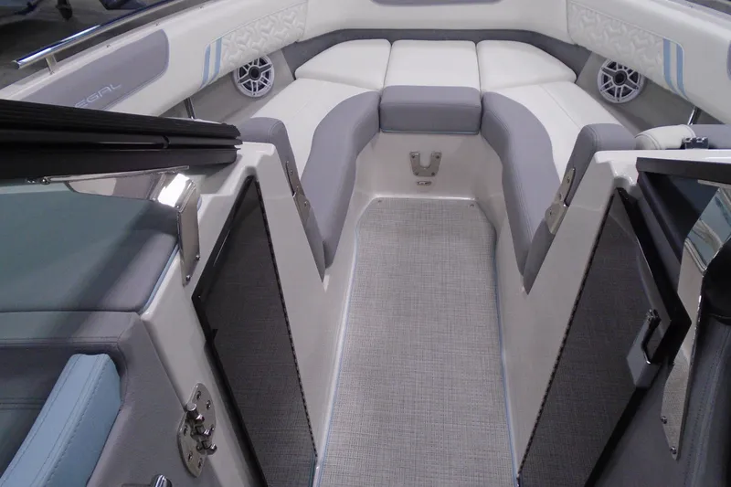 Slide: The Image of 2026 Regal LX6 boat interior with gray and white seating, modern design, and speaker system. - 16
