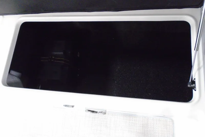 Slide: The Image of Open storage compartment in 2026 Regal LX6 boat. - 21