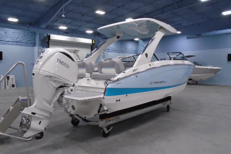 Slide: The Image of 2026 Regal LX6 boat with Yamaha engine in a showroom setting. - 4