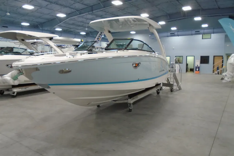 Slide: The Image of 2026 Regal LX6 boat displayed indoors, showcasing sleek design and modern features. - 8