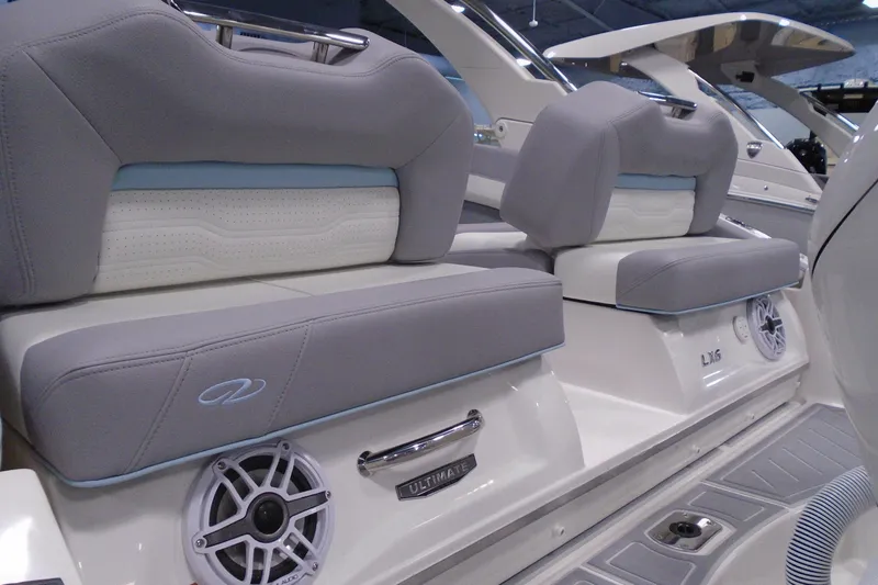 Slide: The Image of 2026 Regal LX6 boat interior with gray seating and speaker detail. - 9