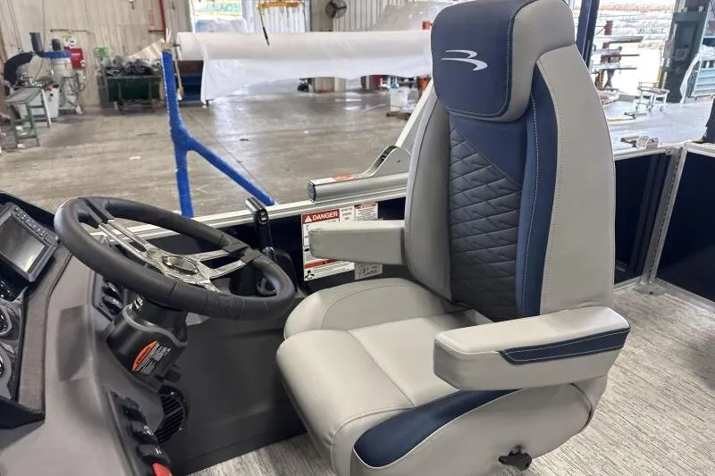 Slide: The Image of Captain's chair and steering wheel of 2026 Bennington 23 SSBSF boat in a workshop setting. - 21