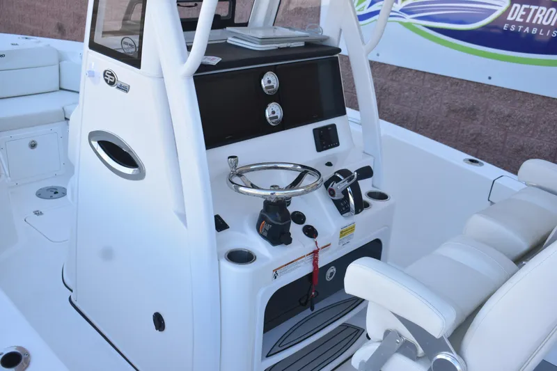 Slide: The Image of 2025 Sea Pro 245 Sandbar boat console with steering wheel and controls. - 11