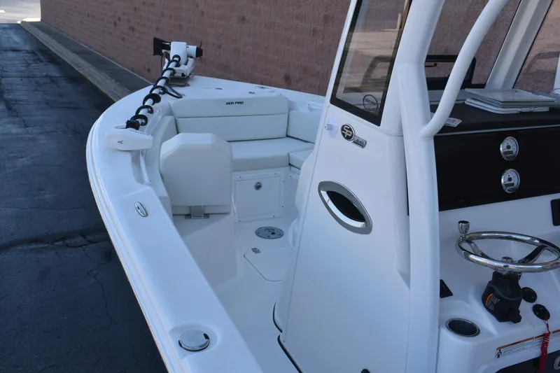 Slide: The Image of 2025 Sea Pro 245 Sandbar boat interior with steering wheel and seating. - 12