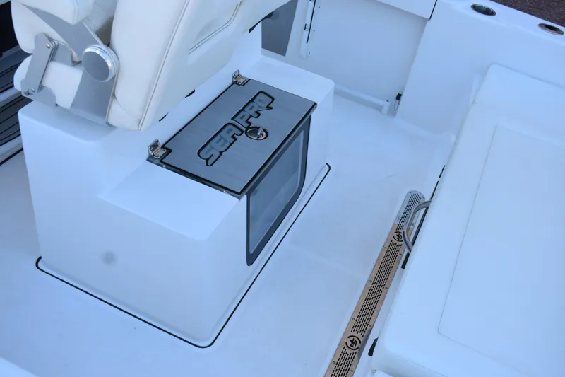 Slide: The Image of 2025 Sea Pro 245 Sandbar boat interior with seating and storage compartment. - 14