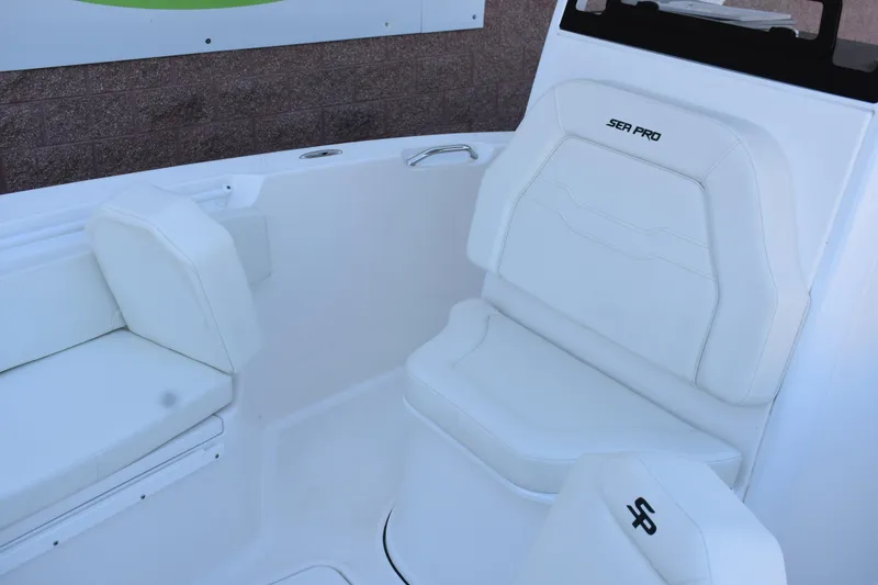 Slide: The Image of 2025 Sea Pro 245 Sandbar boat interior with white seating and sleek design. - 17
