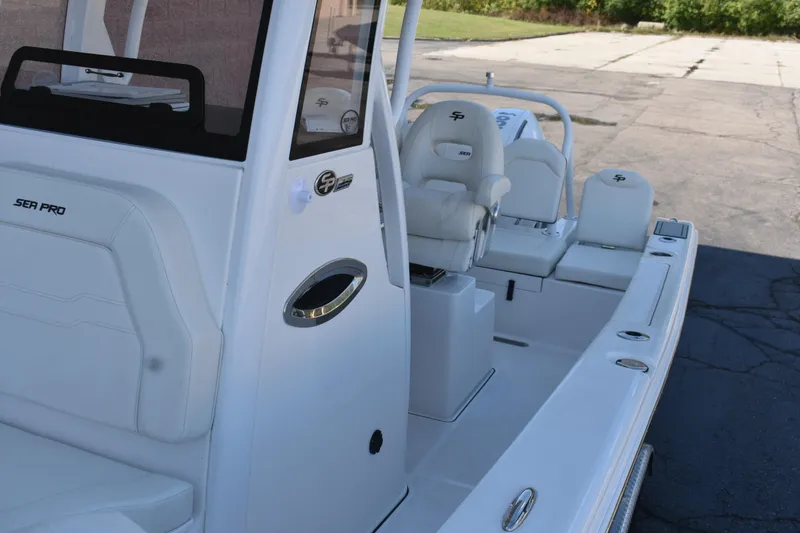 Slide: The Image of 2025 Sea Pro 245 Sandbar boat interior with white seating and console. - 18
