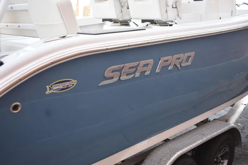Slide: The Image of 2025 Sea Pro 245 Sandbar boat on trailer, featuring sleek blue design. - 20