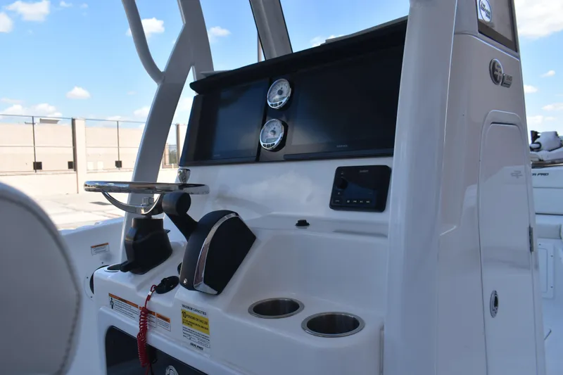 Slide: The Image of 2025 Sea Pro 245 Sandbar boat console with steering wheel and navigation controls. - 26