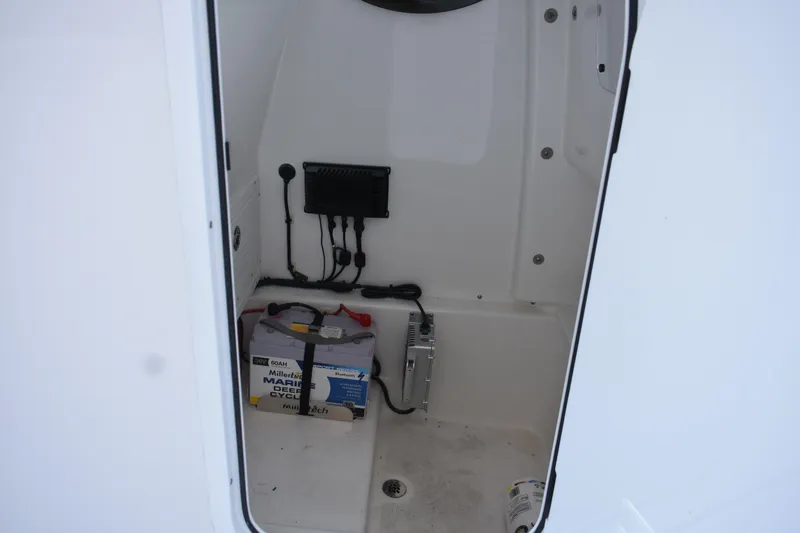 Slide: The Image of 2025 Sea Pro 245 Sandbar boat interior with marine battery and wiring. - 27