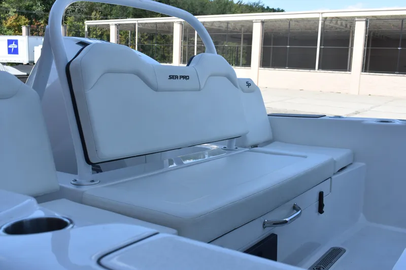Slide: The Image of 2025 Sea Pro 245 Sandbar boat interior with white seating and storage compartments. - 9