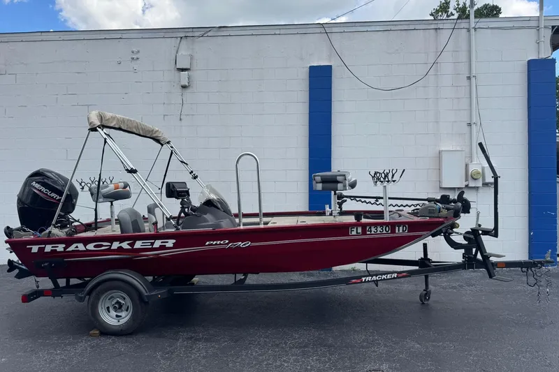 The Image of 2022 Tracker Pro 170 boat on trailer, parked against a white and blue wall. - 0