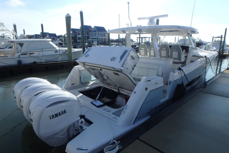 Slide: The Image of 2022 Regal 38 SAV boat cockpit with modern controls and marina view. - 1