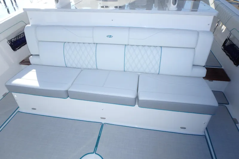 Slide: The Image of 2022 Regal 38 SAV boat interior with spacious seating and cup holders. - 7