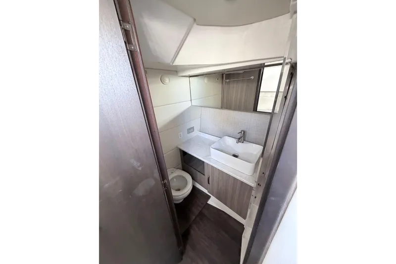 Slide: The Image of Compact bathroom in 2022 Regal 38 SAV yacht with modern sink and toilet. - 9