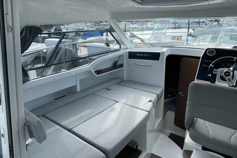 Slide: The Image of Interior of 2020 Beneteau Antares 23 boat with seating and steering wheel. - 12