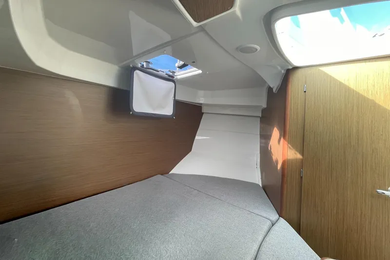 Slide: The Image of Interior cabin of 2020 Beneteau Antares 23 with wood paneling and skylight. - 14